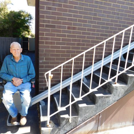 man on Stannah stairlift outside